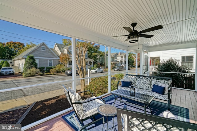 sunroom featuring ceiling fan