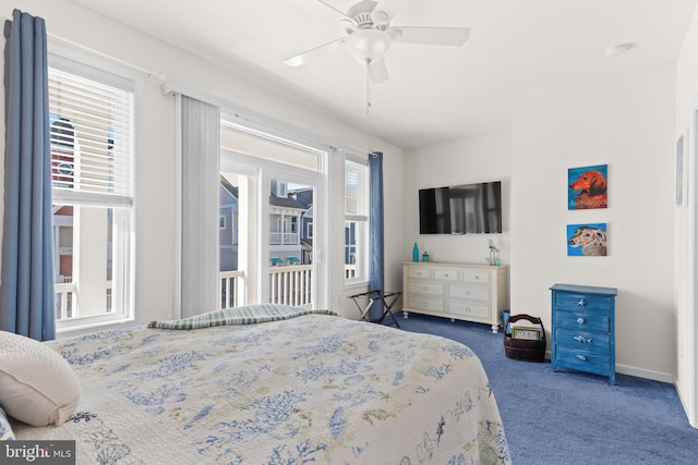 carpeted bedroom with ceiling fan and multiple windows