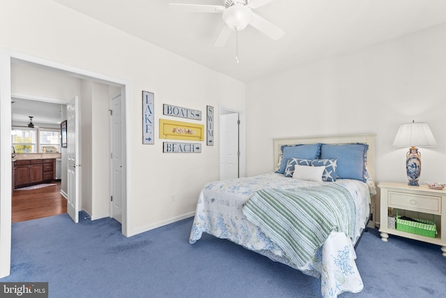 bedroom featuring ceiling fan and dark colored carpet