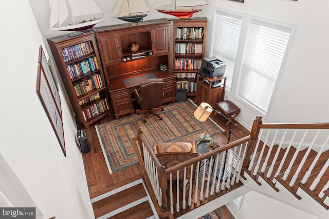 office space with built in desk and hardwood / wood-style flooring