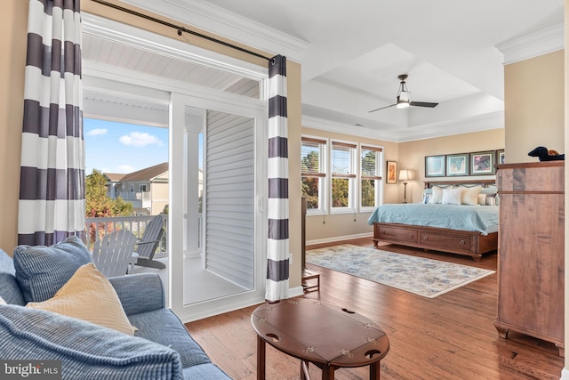 bedroom featuring hardwood / wood-style floors, multiple windows, access to outside, and ceiling fan