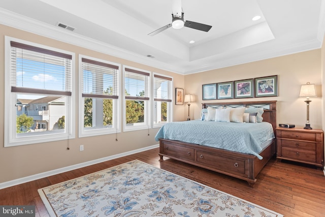 bedroom featuring dark hardwood / wood-style flooring, multiple windows, and ceiling fan