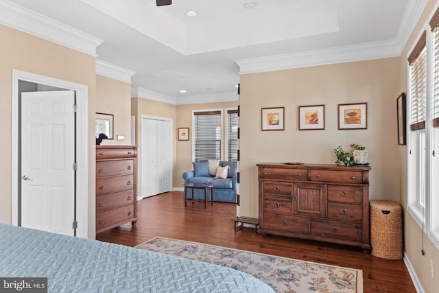 bedroom featuring a closet, crown molding, and dark hardwood / wood-style flooring