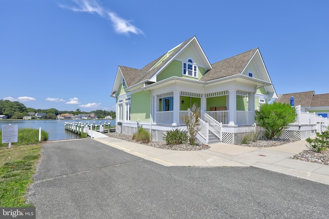 victorian home featuring a water view and a porch