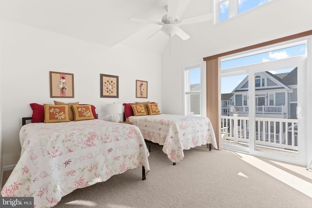 bedroom featuring ceiling fan, carpet flooring, multiple windows, and access to exterior