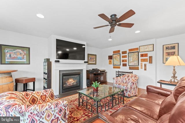 living room with ceiling fan and hardwood / wood-style flooring