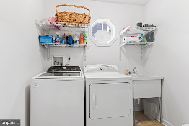 laundry room with sink and separate washer and dryer