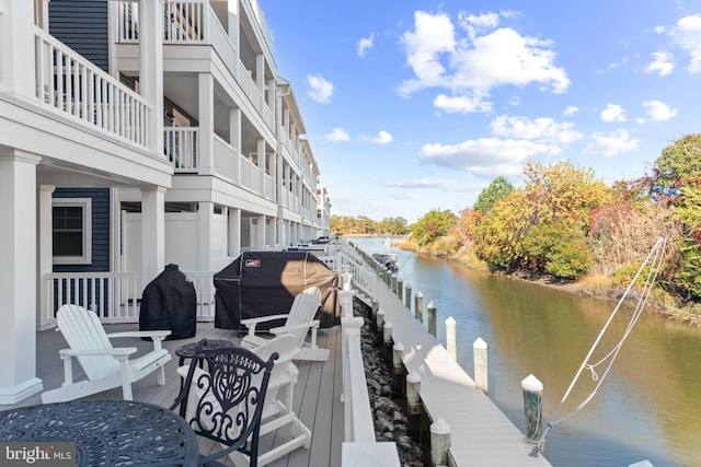 view of dock featuring a balcony and a water view