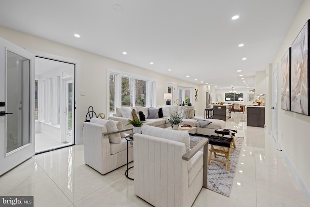 living area featuring light tile patterned floors and recessed lighting