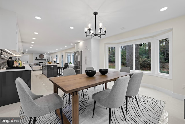 dining area featuring a chandelier, recessed lighting, light tile patterned flooring, and baseboards