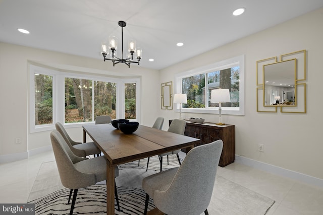 dining area with a notable chandelier, light tile patterned flooring, baseboards, and recessed lighting