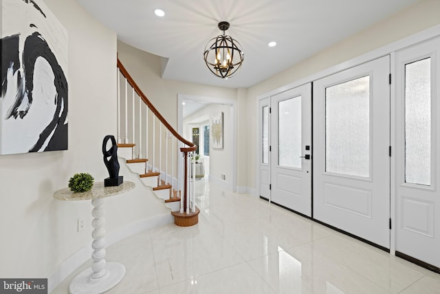 entrance foyer featuring an inviting chandelier, baseboards, stairway, and recessed lighting