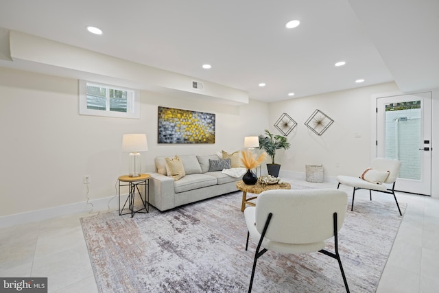 living area with recessed lighting, light tile patterned flooring, visible vents, and baseboards