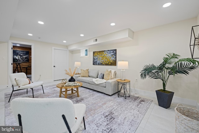 tiled living area featuring baseboards, visible vents, and recessed lighting