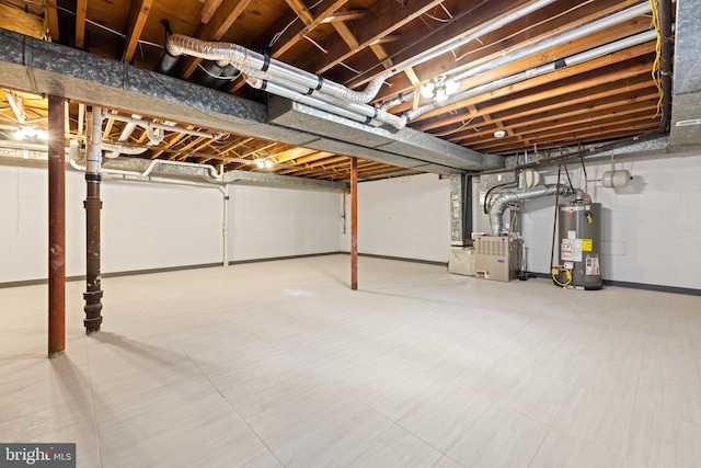 unfinished below grade area with concrete block wall, water heater, heating unit, and tile patterned floors