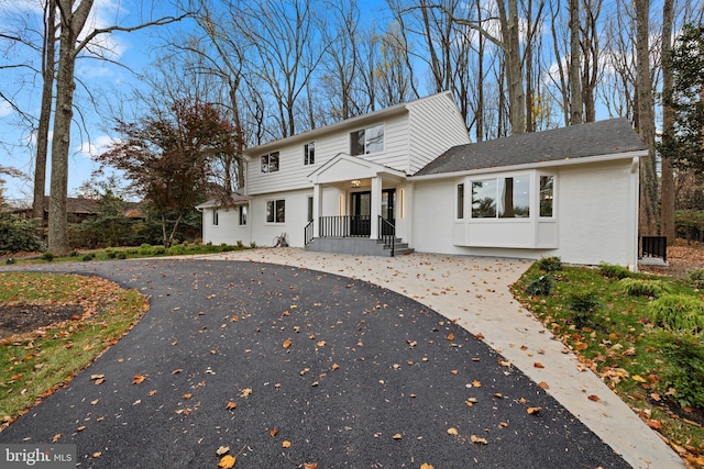 view of front of home featuring brick siding and driveway