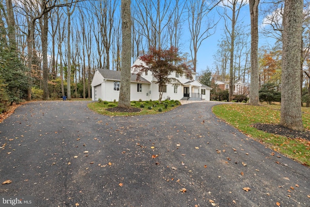 view of front of property with a garage and aphalt driveway