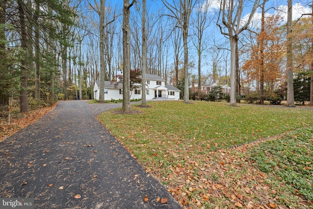 view of front of home featuring a front lawn and aphalt driveway