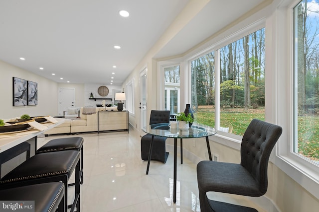 dining space with recessed lighting, plenty of natural light, and light tile patterned floors