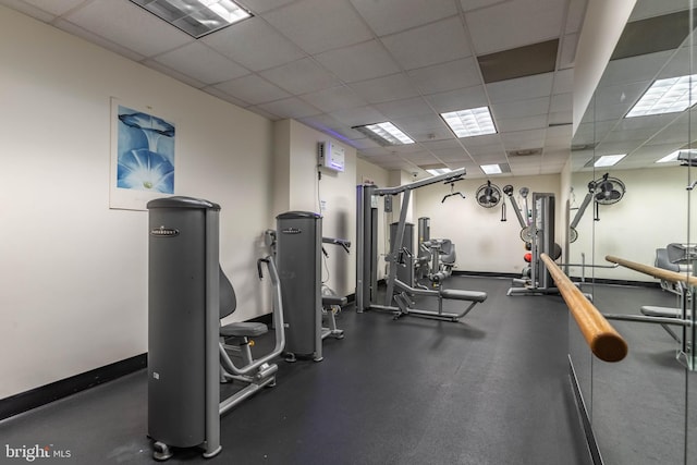 exercise room with a paneled ceiling