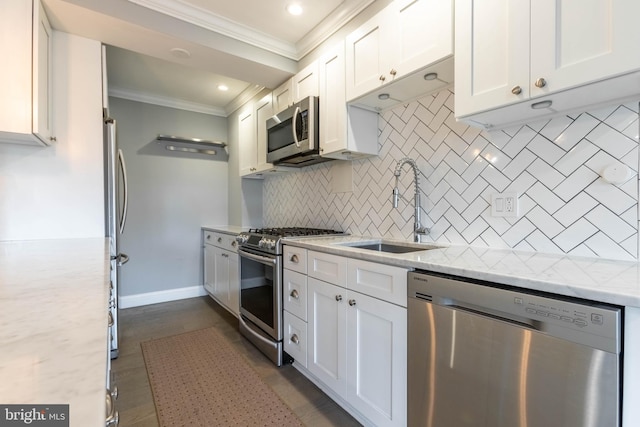 kitchen with light stone counters, appliances with stainless steel finishes, backsplash, and sink