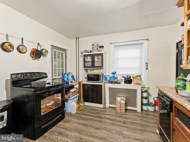 kitchen with dark hardwood / wood-style floors, beverage cooler, and black appliances