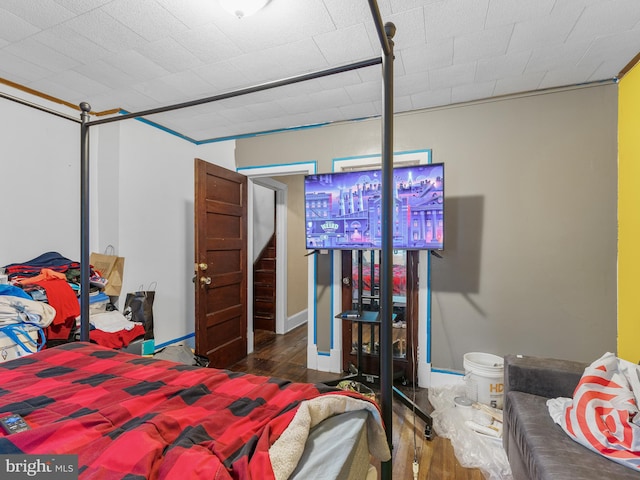 bedroom with dark hardwood / wood-style flooring