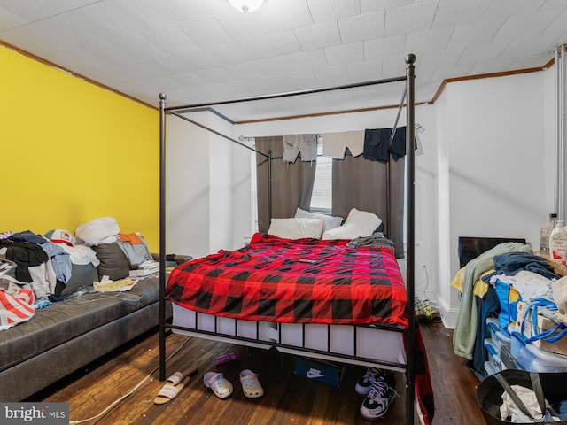 bedroom featuring crown molding and hardwood / wood-style floors