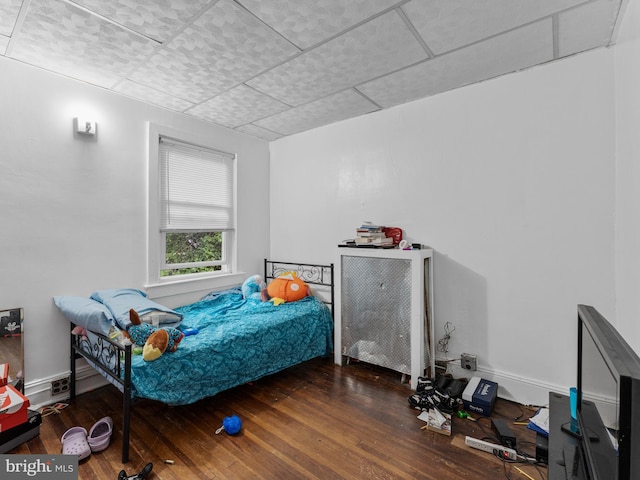 bedroom with dark hardwood / wood-style flooring