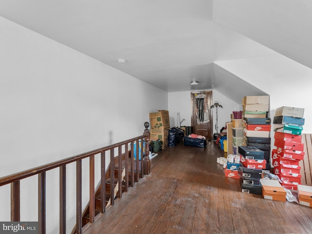 additional living space featuring lofted ceiling and dark hardwood / wood-style flooring