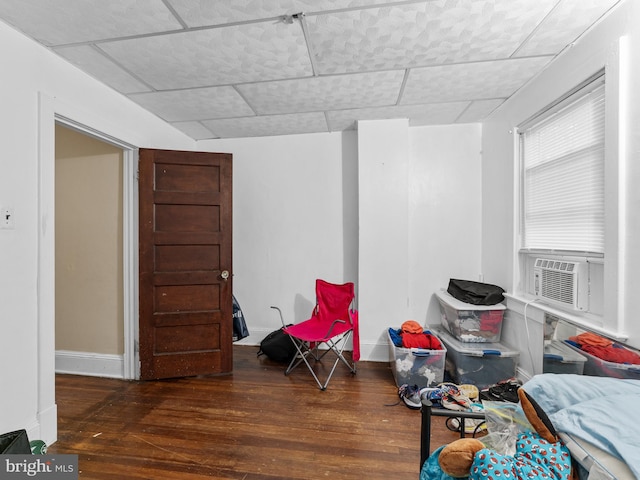 living area with cooling unit and dark wood-type flooring