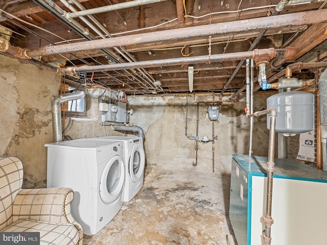 basement featuring electric panel and washer and dryer