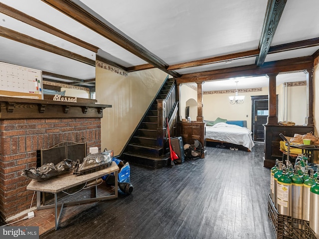 interior space with wood-type flooring, beamed ceiling, and a fireplace