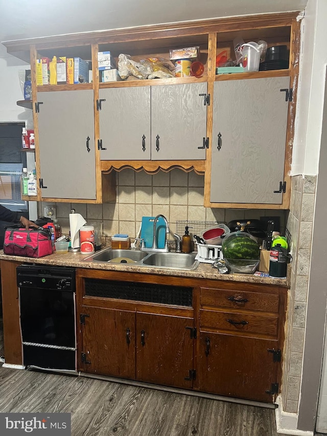 kitchen with hardwood / wood-style flooring, decorative backsplash, sink, and dishwasher