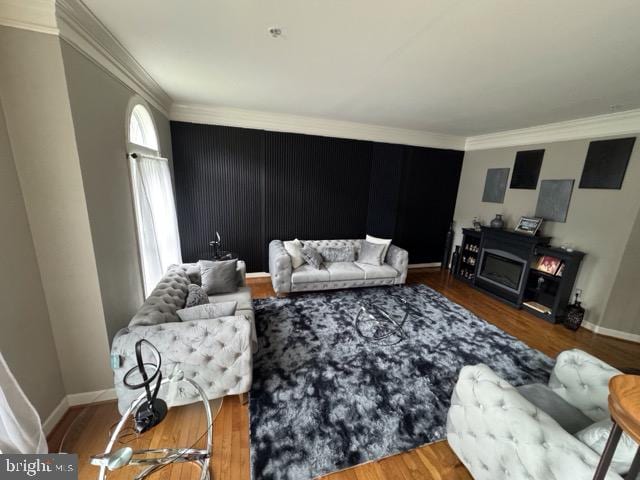 living room with hardwood / wood-style flooring and crown molding