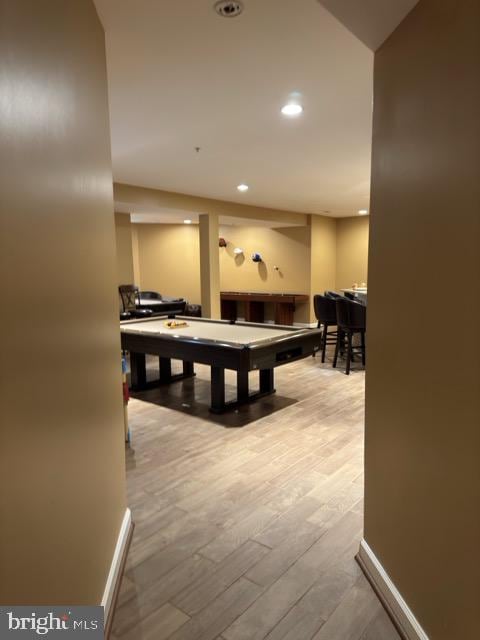 game room with wood-type flooring and pool table