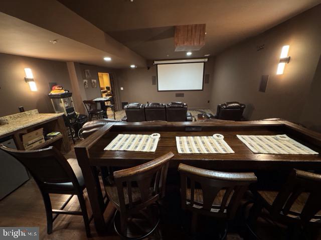 home theater room with wood-type flooring