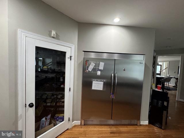 kitchen featuring built in fridge and light hardwood / wood-style floors