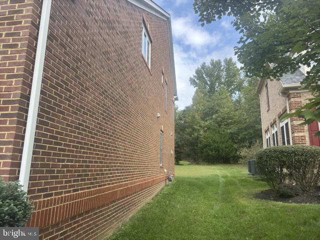 view of property exterior featuring a lawn