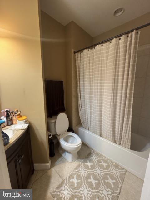 full bathroom featuring tile patterned floors, shower / tub combo, toilet, and vanity