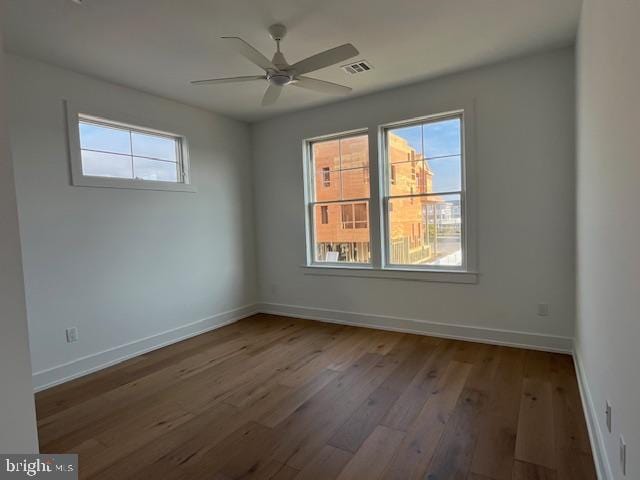 empty room featuring hardwood / wood-style flooring and ceiling fan