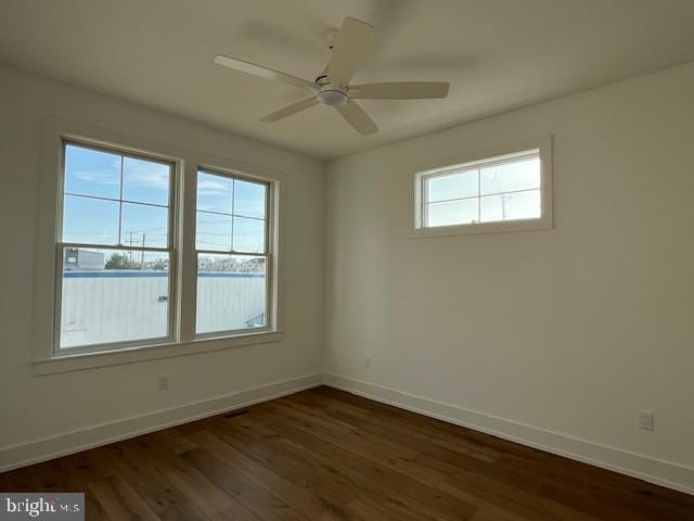 unfurnished room with ceiling fan and dark hardwood / wood-style flooring