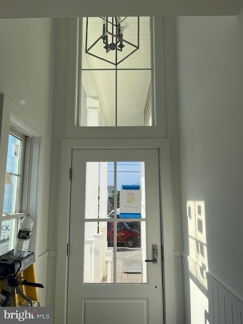 doorway featuring a wealth of natural light and a notable chandelier