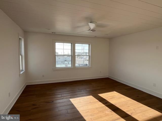 spare room featuring ceiling fan and dark hardwood / wood-style flooring