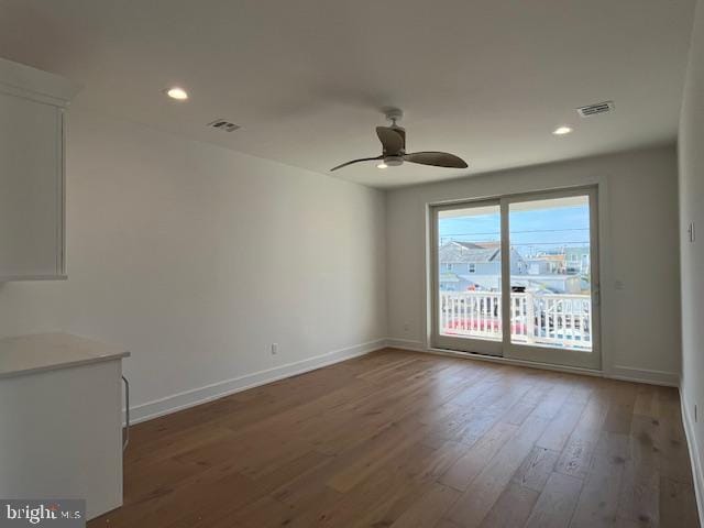 unfurnished room with wood-type flooring and ceiling fan