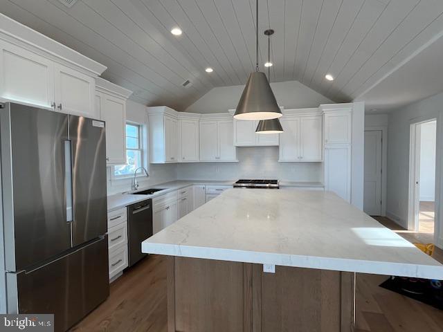 kitchen featuring appliances with stainless steel finishes, sink, wooden ceiling, hanging light fixtures, and a large island