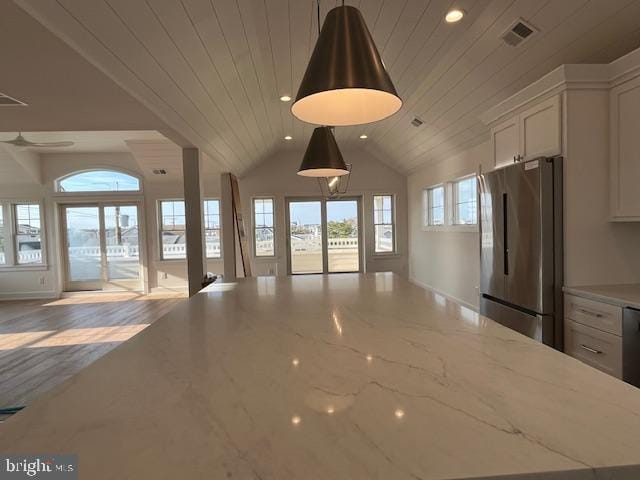 unfurnished living room with plenty of natural light, wooden ceiling, and vaulted ceiling