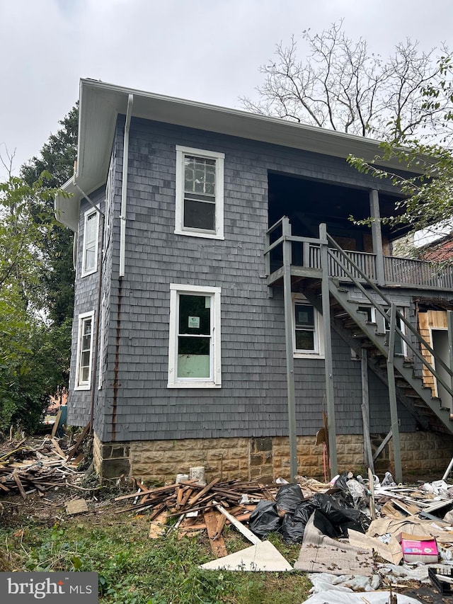 view of side of home featuring stairway