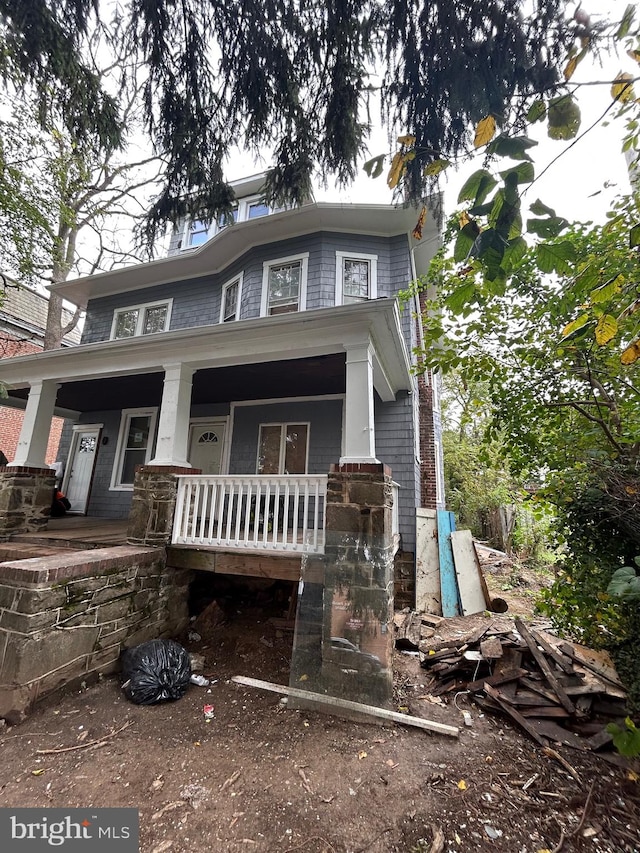 traditional style home featuring covered porch