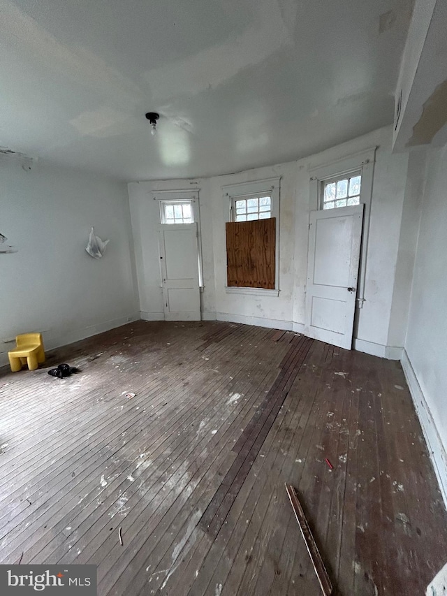 entryway with plenty of natural light, baseboards, and hardwood / wood-style floors